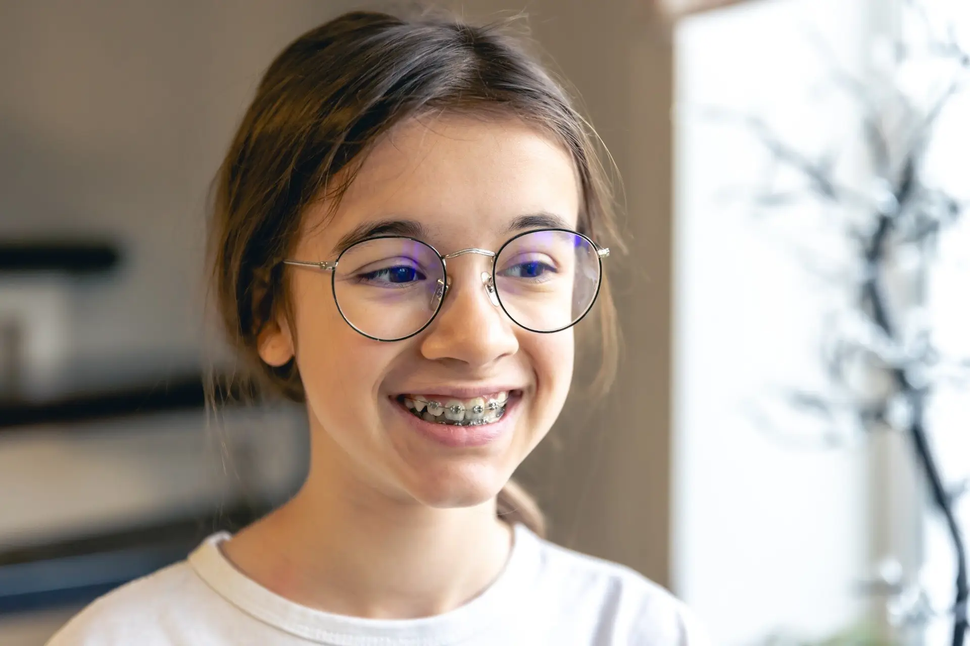 Smiling girl in glasses wearing braces