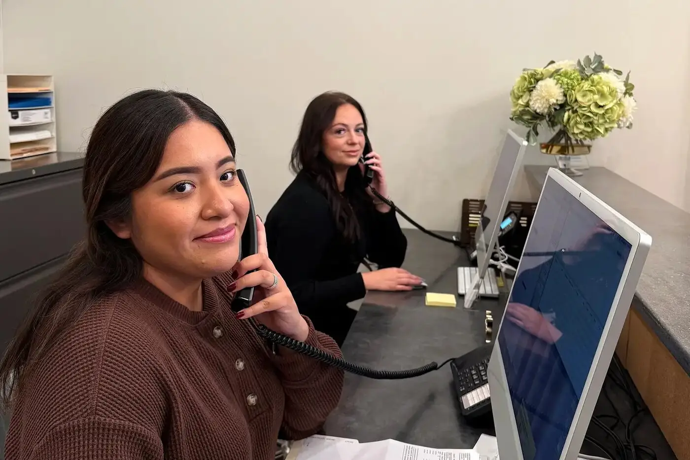 Patient coordinators answering calls at the Costalos Orthodontics front desk