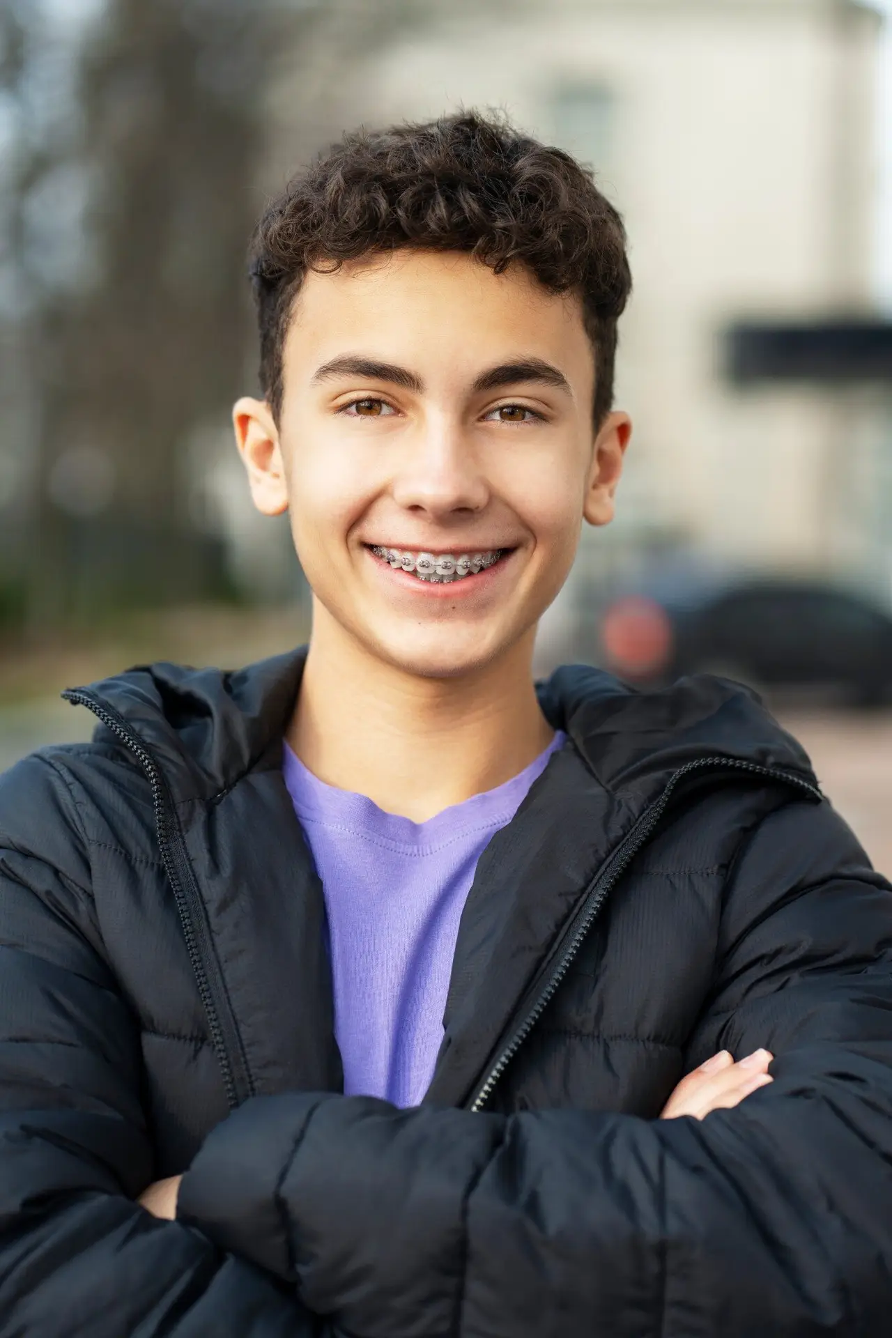 Confident teen boy with braces smiling outdoors